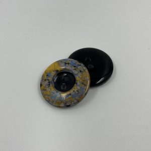 Coat button, resin, intensly iridescent rim gold and light grey and black centre