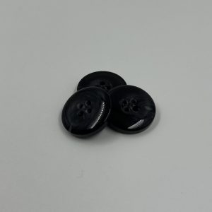 Black button, with a  swirl of colour.